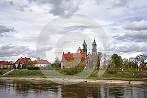 Historic buildings and towers of the cathedral on the river Warta in the city of Poznan photo