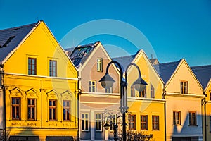 Historic burgher houses on the square lit by the morning sun