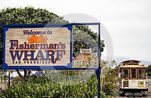 Historic Cable Car, Powell-Hyde line and Fisherman`s Wharf welcome sign on the August 17th, 2017 - San Francisco, California, CA