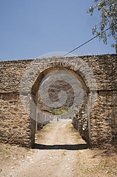 Casa Hacienda de Yaca from the abandoned and dilapidated sugar industry arc and door dirth road 20th century adobe