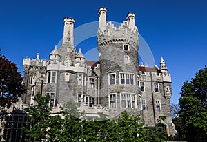 Historic castle Casa Loma, front side. old house doors. Sunny day blue sky