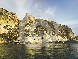 Historic castle ruins on a cliff over water at the Tremiti Islands in Puglia, Italy