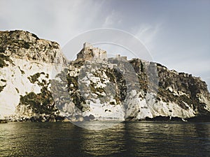 Historic castle ruins on a cliff over water at the Tremiti Islands in Puglia, Italy