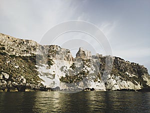 Historic castle ruins on a cliff over water at the Tremiti Islands in Puglia, Italy