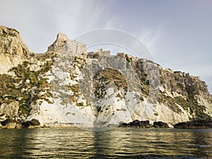 Historic castle ruins on a cliff over water at the Tremiti Islands in Puglia, Italy