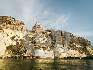 Historic castle ruins on a cliff over water at the Tremiti Islands in Puglia, Italy