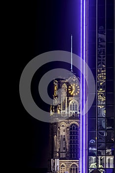 Historic church steeple and illuminated office tower