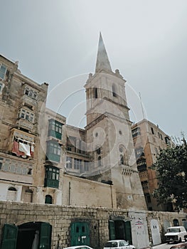 Historic church in stone architecture inbetween apartment buildings