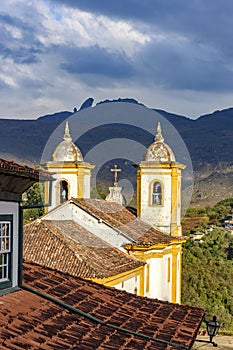 Historic church towers with the mountains in the background