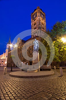 Historic city center in Torun. Statue of astronomer Nicolaus Copernicus and the Town Hall. Torun, Poland