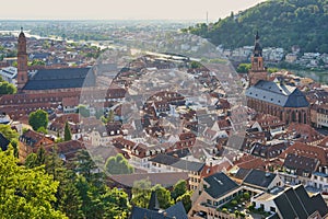 The historic city of Heidelberg with two churches and river Neckar in the evening sun. Germany