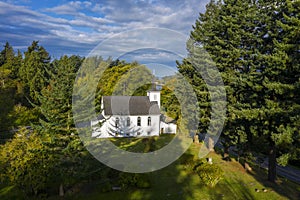 Historic Classic White Rural Church Nestled in the Forest.