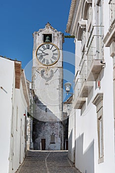 Historic clock tower view - Church of Santa Maria do Castelo- in the city Tavira, Algarve, Portugal