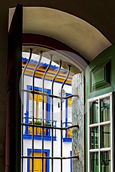 Historic colonial style house seen through the window