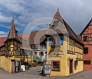 Historic colorful half-timbered houses and wine cellars in the village center of Eguisheim