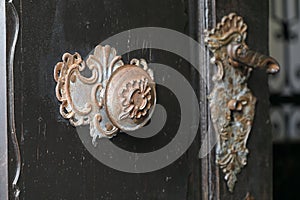 An historic doorknob and a doorhandles on the door of an old church in Krems, Lower Austria