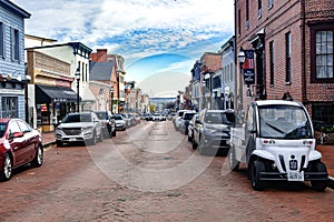 Historic downtown Annapolis in Maryland. Cozy narrow streets with shops and brick pavement