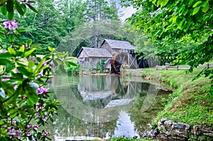 Historic Edwin B. Mabry Grist Mill (Mabry Mill) in rural Virginia on Blue Ridge Parkway and reflection on pond in summer