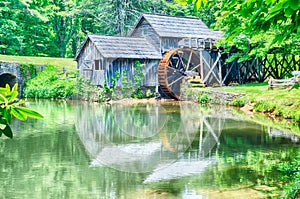 Historic Edwin B. Mabry Grist Mill (Mabry Mill) in rural Virginia on Blue Ridge Parkway and reflection on pond in summer