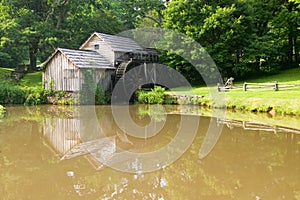 Historic Edwin B. Mabry Grist Mill (Mabry Mill) in rural Virginia on Blue Ridge Parkway and reflection on pond in summer