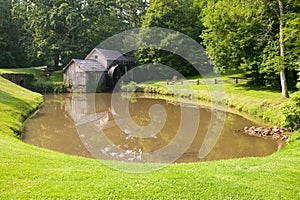 Historic Edwin B. Mabry Grist Mill (Mabry Mill) in rural Virginia on Blue Ridge Parkway and reflection on pond in summer