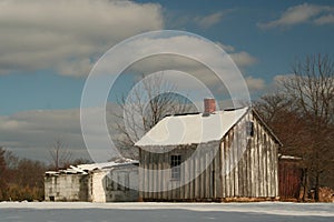 Historic farm buildings in a winter landscape