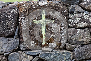 Historic field cross carved into ancient lava rock in Caldeira de Santo Cristo, Sao Jorge, Azores