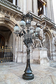 A historic, forged, vintage lantern, set near the main entrance to the Opera House of Paris. France