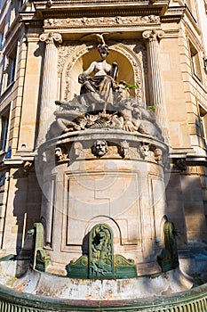Historic fountain at a building in Paris, France