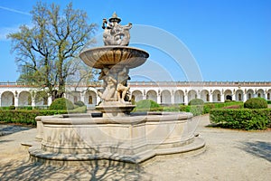 Historic fountain and long white colonnade