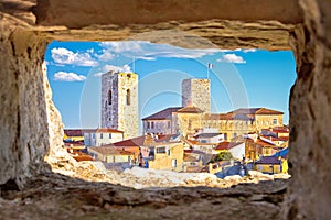 Historic French riviera old town of Antibes seafront and rooftops view through stone window