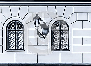 Historic gas lamp on old wall. With shadow. Aged lantern