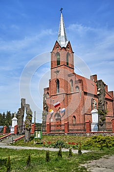 The historic Gothic red brick church with belfry in the village of Sokola Dabrowa