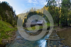 A historic grist mill building on the banks of Creek in Carpathian mountains, Slovakia, Europe. Old mill powered by water