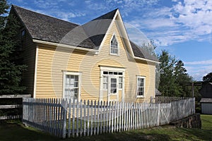 A historic house in Sherbrooke village Nova Scotia with a white picket fence