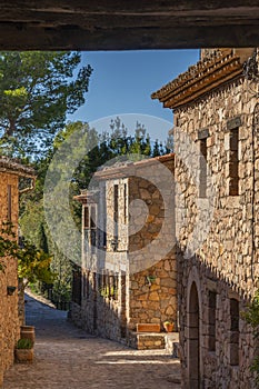 Historic houses in the center of mountain village Siurana with blue sky, Tarragona