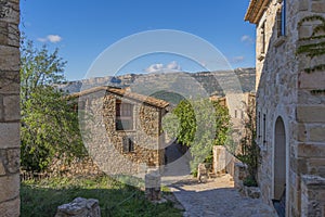 Historic houses in the center of mountain village Siurana with blue sky, Tarragona