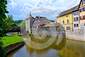 Historic houses, tower of city wall and ancient wooden bridge in Schwabisch Hall, Germany