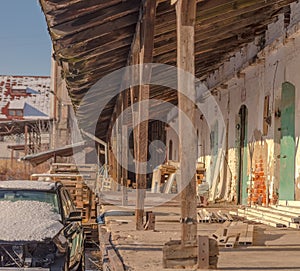 Historic industrial building with a long loading ramp along the wall .