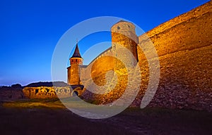 Historic Kamianets-Podilskyi Castle in evening illumination, Ukraine