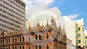 The historic landmark Beehive Corner against modern buildings in Adelaide, South Australia