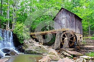 A historic mill in a forest with green leafs in late spring. photo