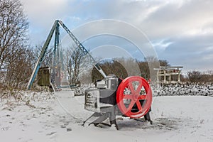 Historic mining equipment in snow at Tegg`s Nose Country Park, Macclesfield, UK