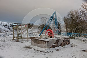 Historic mining equipment in snow at Tegg`s Nose Country Park, Macclesfield, UK