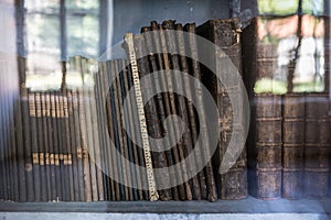 Historic old books in library, wooden bookshelf