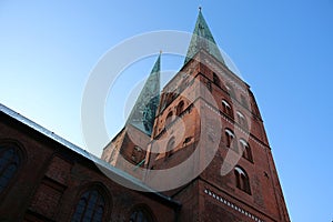 a Historic old church in Lübeck in a worm\'s eye view with a bright blue sky