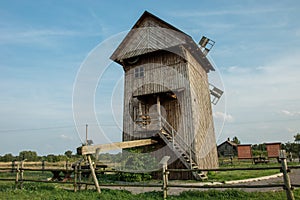 Historic old Polish wooden windmill and blue sky