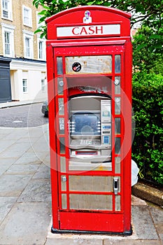 Historic red phone box as cash machine, London, UK