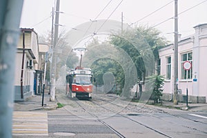 Historic red tram in the fog on the street in the moning photo