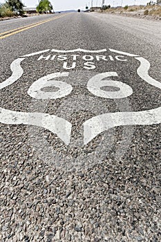 Historic Route 66 sign painted on asphalt of highway in Arizona - California